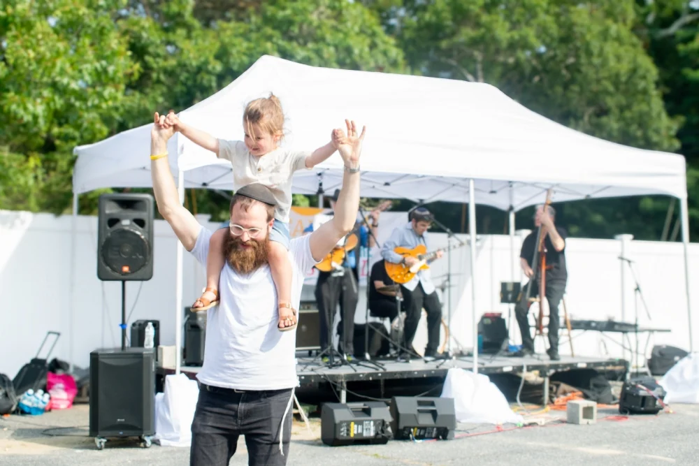 A father and his joyful child enjoying the live music